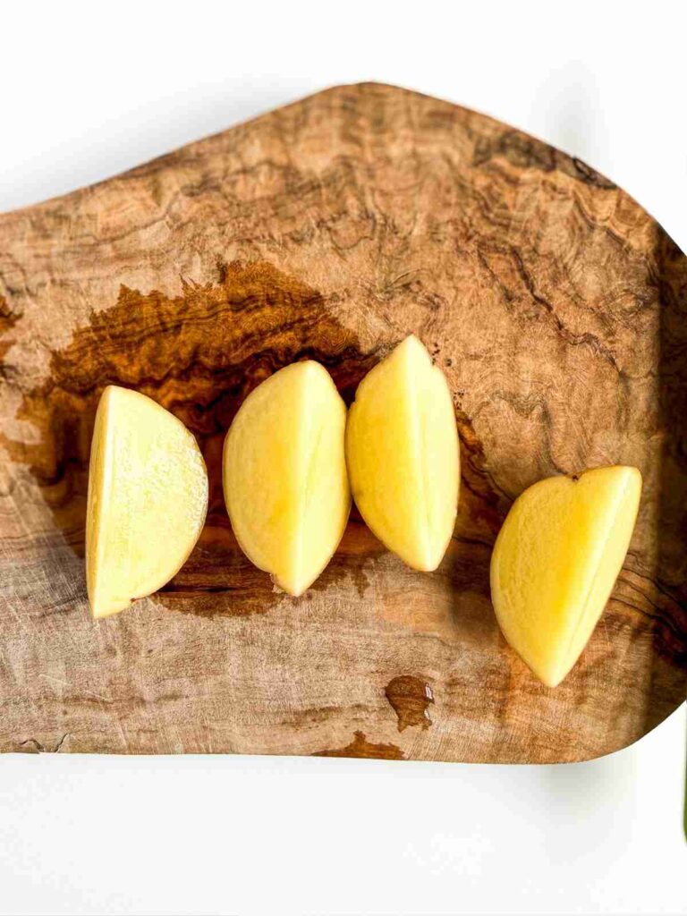 small potato cut on a cutting board
