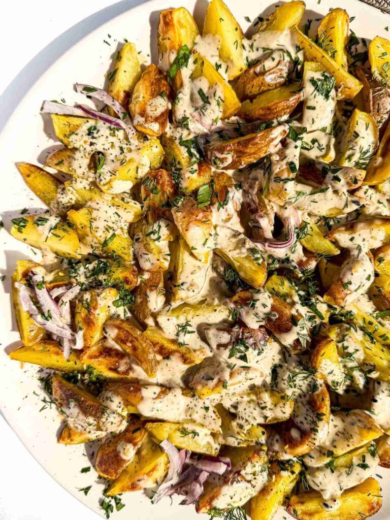 overhead view of Crispy Potatoes with Everything Dill Tahini on a plate