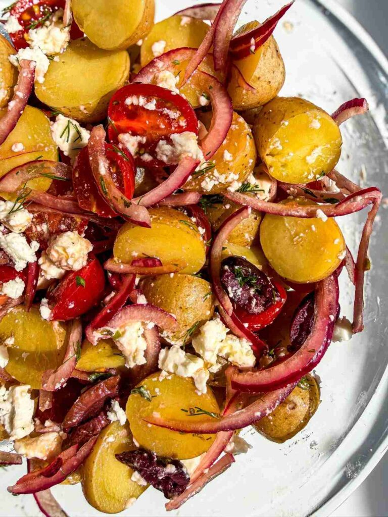 overehad view of Greek Potato Salad in a mixing bowl