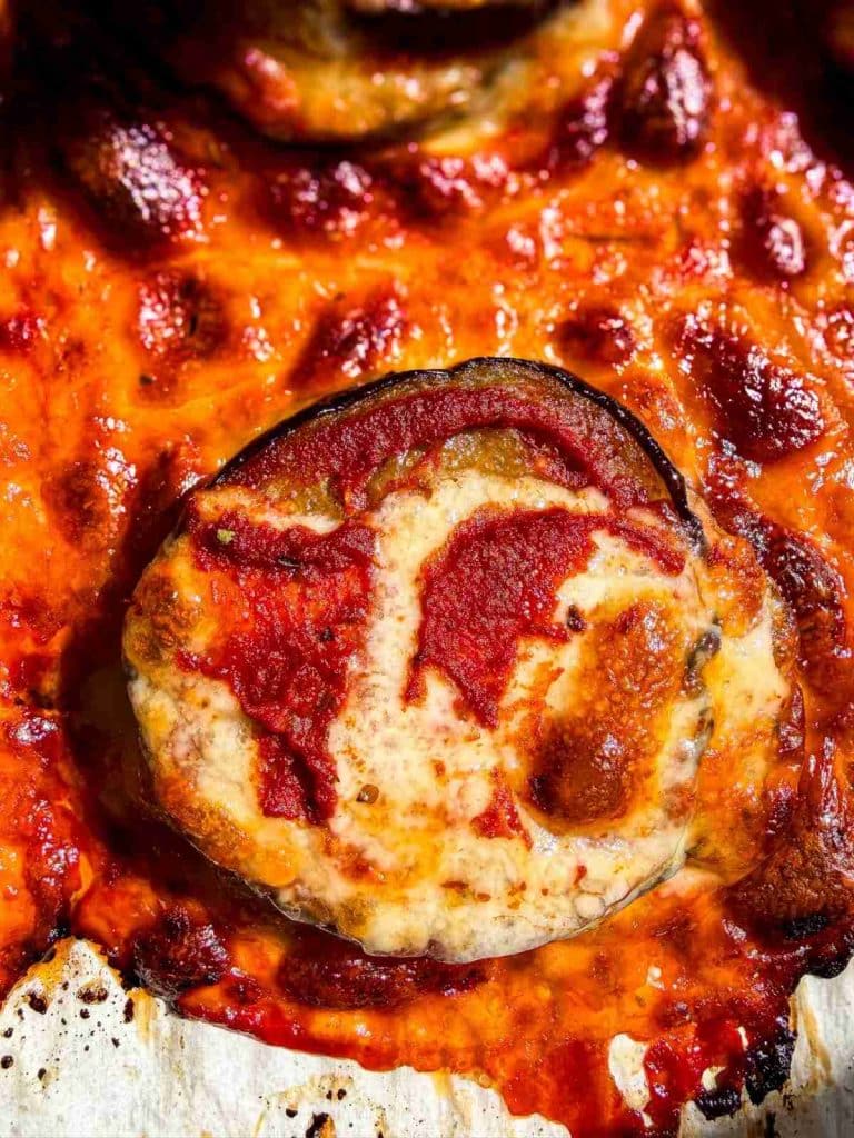 overhead view of Saucy and Cheesy Oven Baked Eggplant Bites on a baking sheet