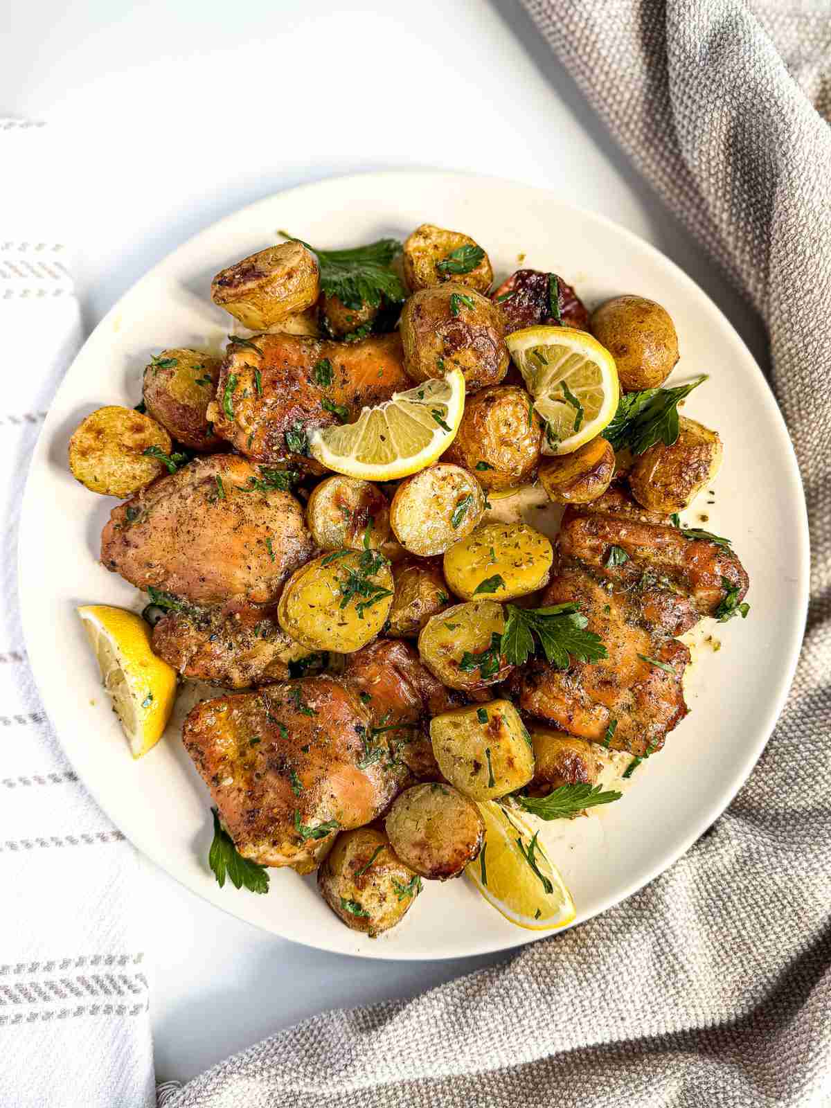 overhead view of Lemon Dill Baked Chicken Thighs and Potatoes in a plate