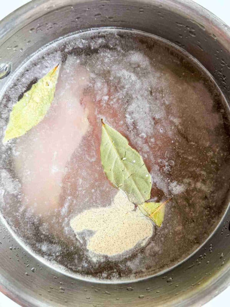 overhead view of chicken breasts cooking for high-protein-dill-pickle-chicken-salad-with-zero-mayo-1
