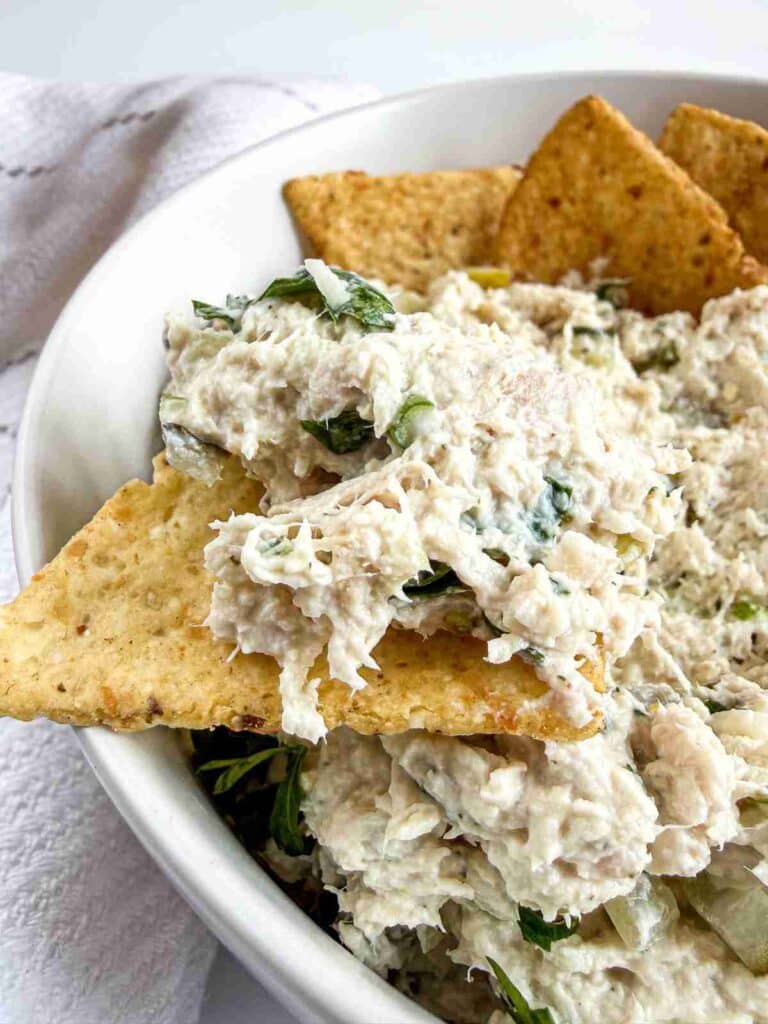 side view of dill pickle chicken salad on a chip