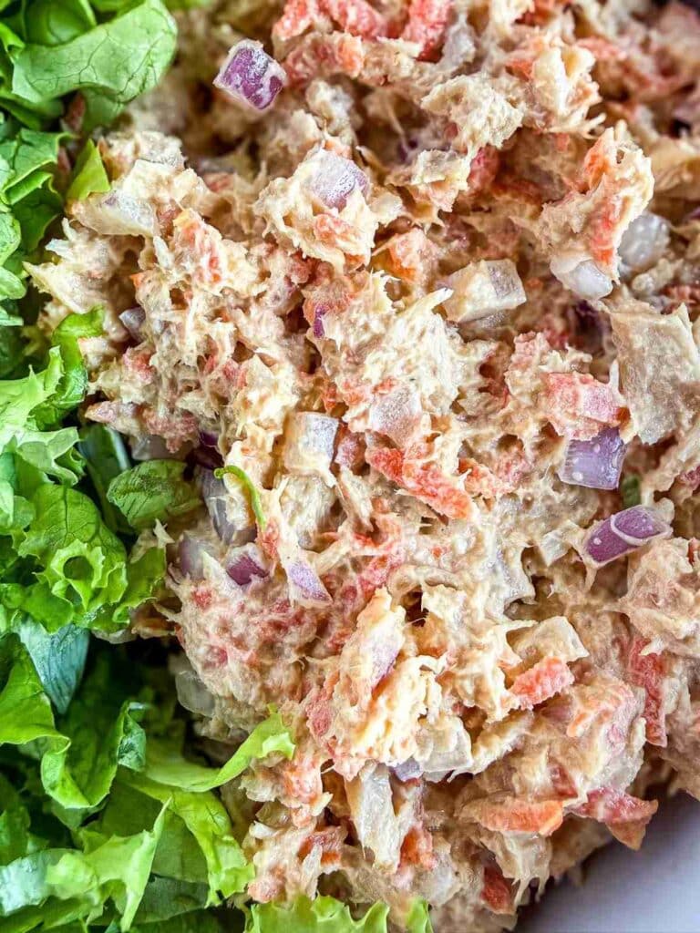 overhead view of tuna salad in a bowl with lettuce