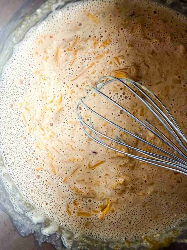 Cheese added to make Homemade Nacho Cheese Sauce with spices