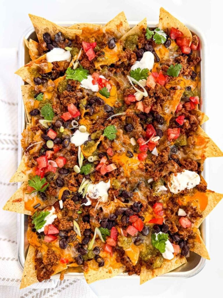 overhead view of Loaded Seasoned Ground Beef Nachos in a sheet pan