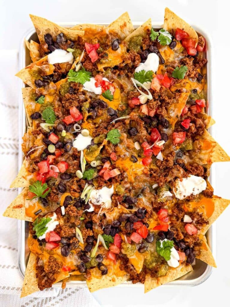 overhead view of Loaded Seasoned Ground Beef Nachos for Toppings for Nachos on a baking sheet