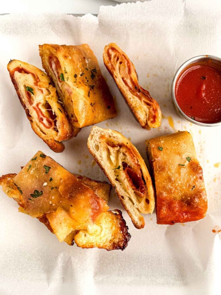 overhead view of sliced stromboli with marinara sauce