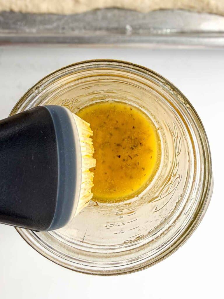 overhead view of melted butter with spices in a glass container
