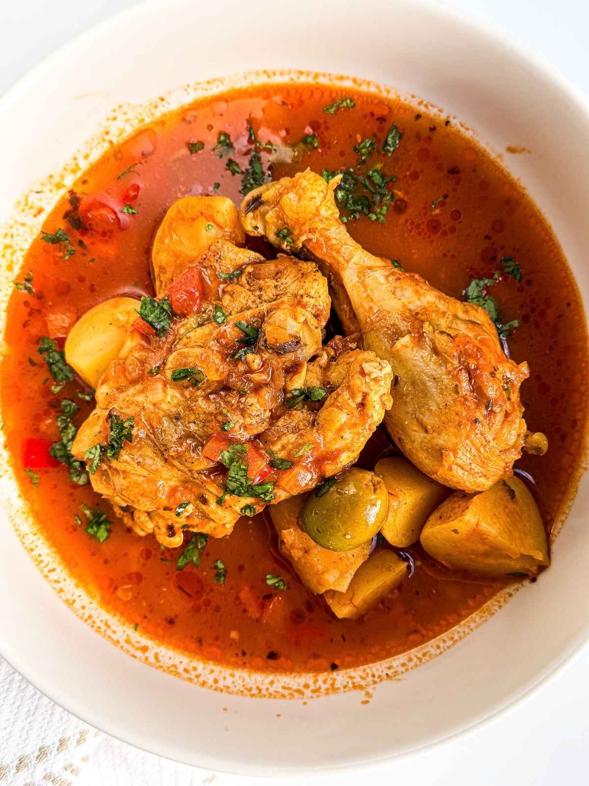 overhead view of pollo guisado in a bowl